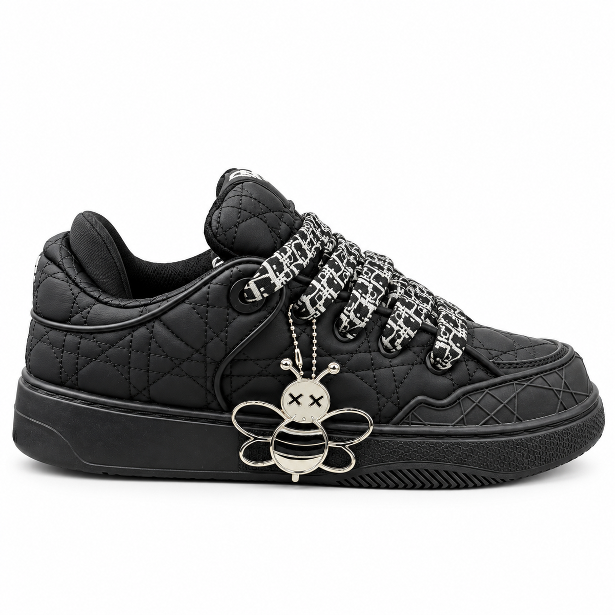 black Dior B9S Skater sneaker with a quilted Cannage pattern, patterned laces, and a silver bee charm.