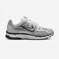 Nike P-6000 sneaker features a striking metallic silver upper with sporty black accents